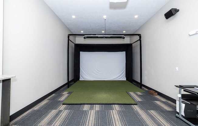 A room with a yoga mat on the floor and a projection screen on the wall.