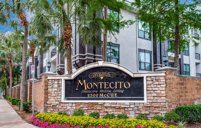 a sign in front of a building with palm trees