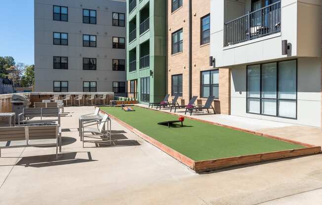 Hibernia resident amenity deck with gaming turf, conversational seating and grilling station