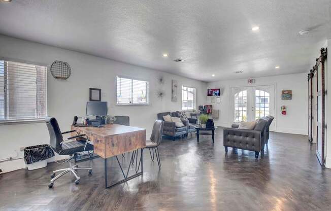 A spacious room with a wooden table and chairs.
