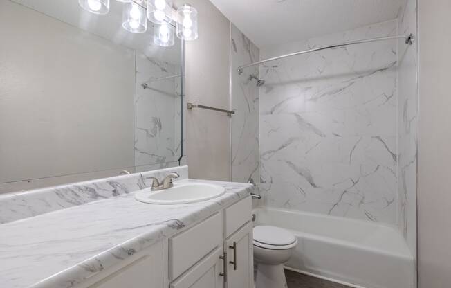 a bathroom with a sink and a tub and a toilet