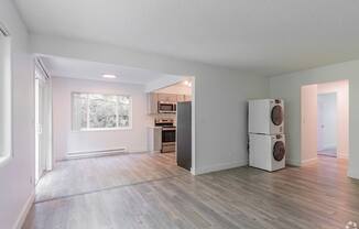 A kitchen area with a refrigerator, oven, and microwave.