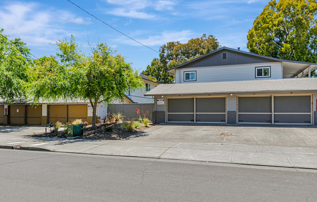 A house with a grey roof and a grey garage door.