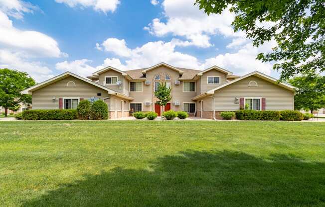 a home with a large lawn in front of it