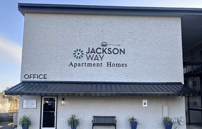 Jackson Way Apartment Homes office building with a black awning.