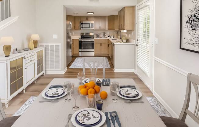 four place settings on a table in the dining room of a Gallatin apartment