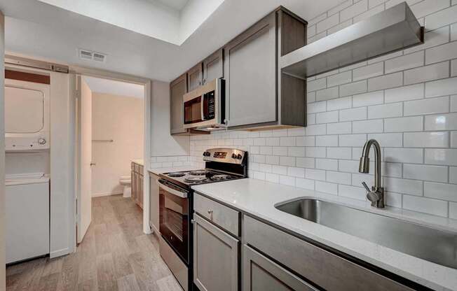 A kitchen with a white fridge and a stove top oven.