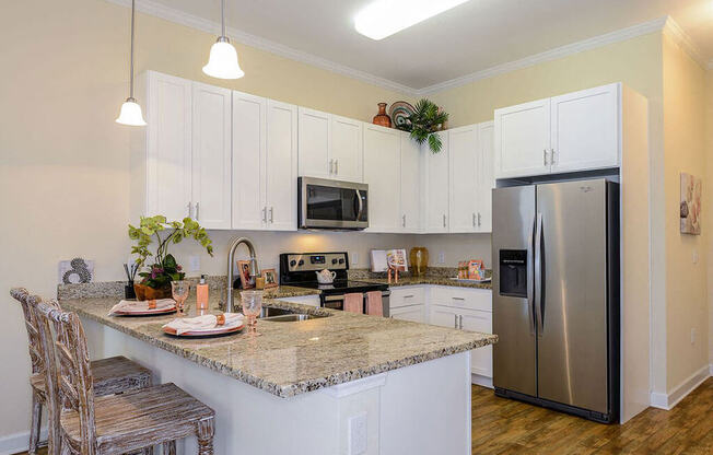 a kitchen with white cabinets and a granite counter top  at Palm Bay Club, Jacksonville, 32258
