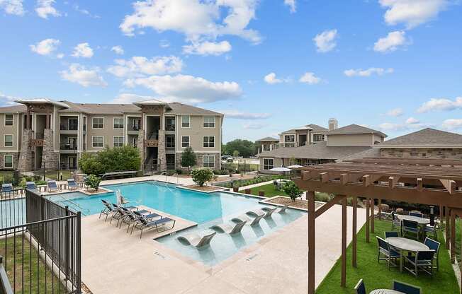 our apartments have a large swimming pool with chairs and tables