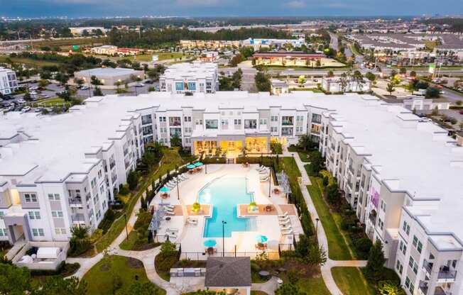 an aerial view of a building with a swimming pool  at Linden on the GreeneWay, Orlando, 32824