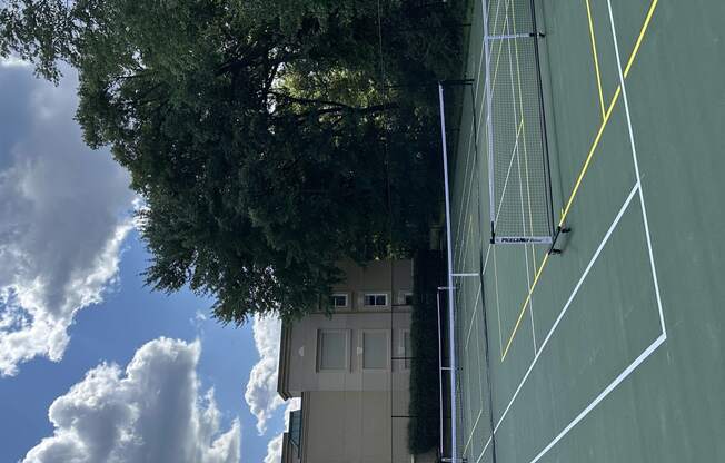 a view of a house from the roof of a tennis court