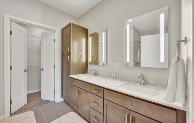 a bathroom with a large vanity with two sinks and two mirrors