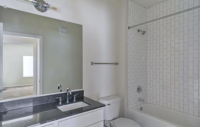 Ashland Farms Bathroom with Granite Counters, Modern Fixtures, and Shower Tub Combo