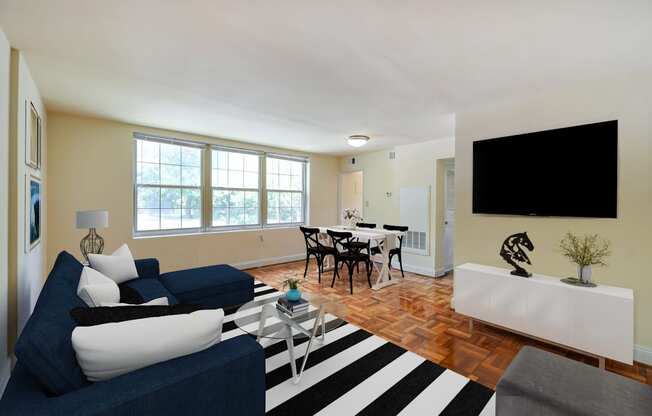 living area with sofa, coffee table, credenza, tv , large windows and view of dining area at shipley park apartments in washington dc