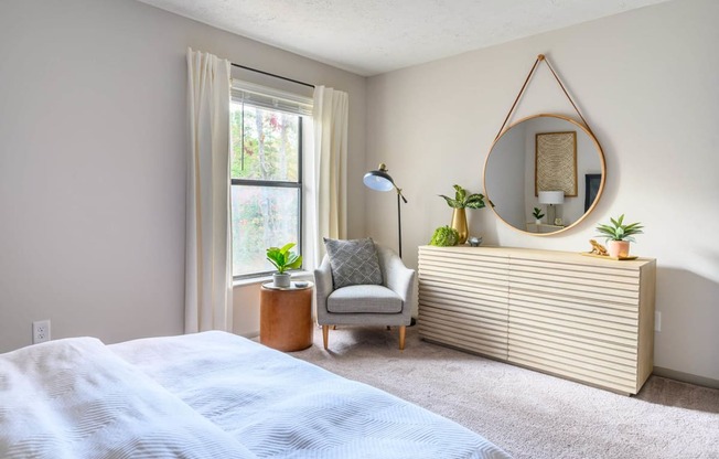 Atria bedroom with sunshine coming through the window at Atria at Crabtree Valley, North Carolina