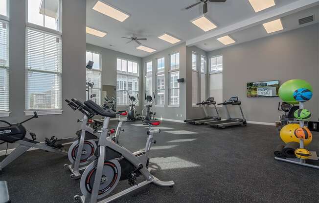 an indoor gym with exercise bikes and windows