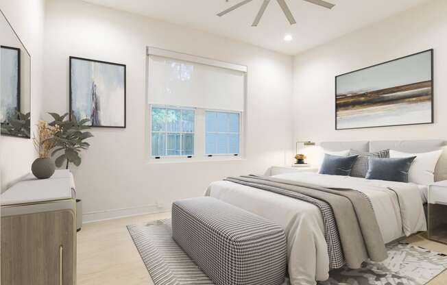 a white bedroom with a bed and a ceiling fan