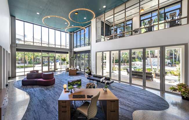 a large room with a desk and a lot of windows