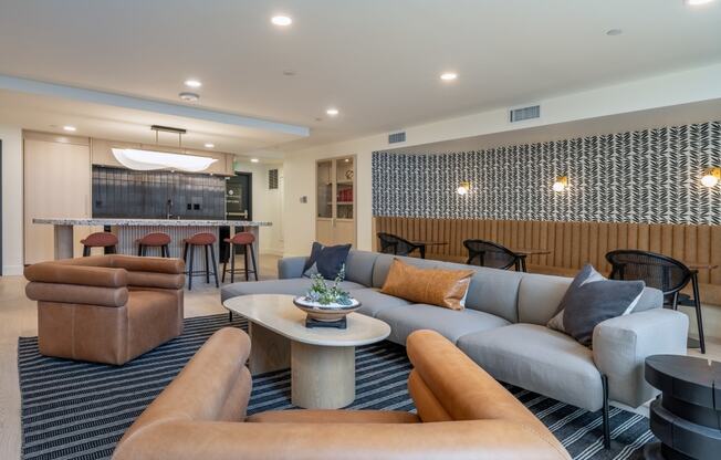 a living room with couches and chairs and a table