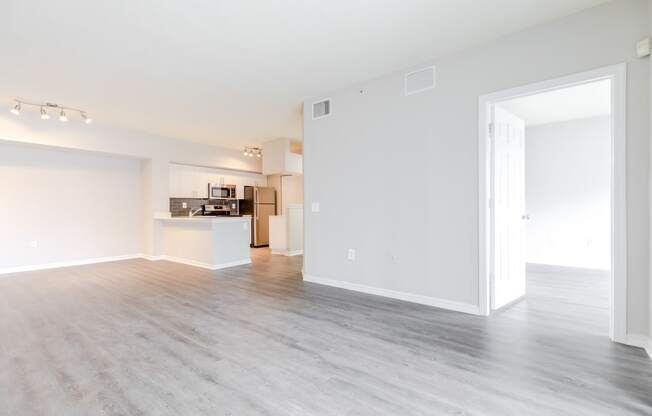 an empty living room with a kitchen in the background at Heritage Bay, Jensen Beach, FL 34957