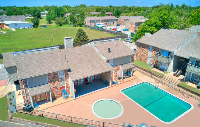 a aerial view of a house with a basketball court and a pool