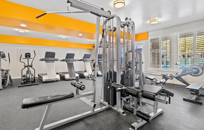 Community workout room with bikes, treadmills, and weight equipment