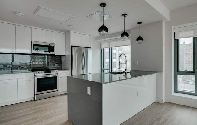 A modern kitchen with a large island in the center.