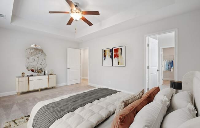 Harris Trail Luxury Townhomes for rent Richmond Hill, GA photo of a bedroom with a large bed and a ceiling fan