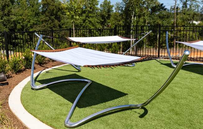 a hammock area in a park with trees in the background