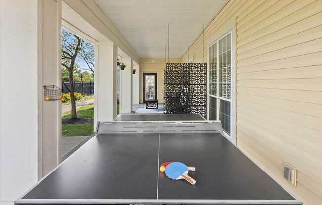 a ping pong table on the side of a house
