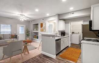 A modern kitchen with white appliances and a dining area with a table and chairs.