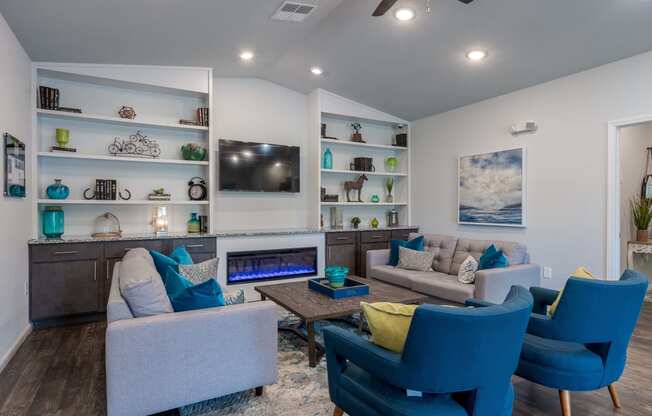 a living room with blue chairs and couches