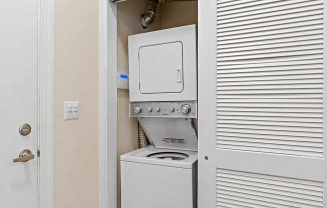 the laundry room has a washer and dryer and a white door