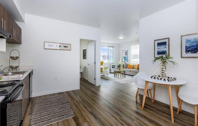 a kitchen and living room with wood floors and white walls at Jefferson Yards, Washington, 98402