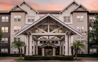 A large, modern building with a central entrance and a covered walkway.