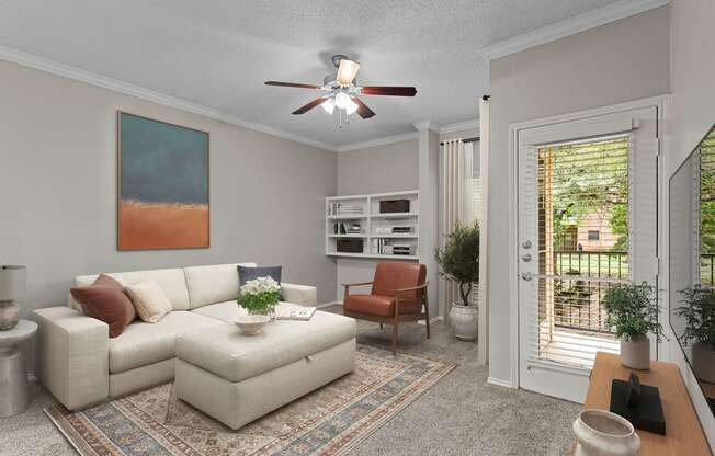 a living room with a white couch and a ceiling fan