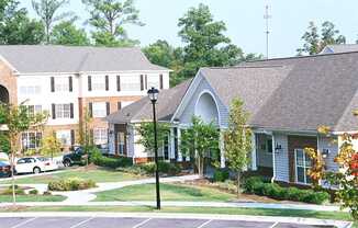 A street view of a residential area with a house and a car.
