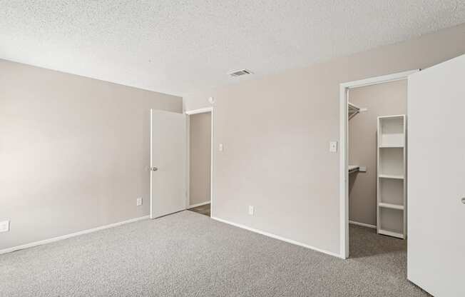 B6 bedroom with a closet, carpet, and white walls at Windridge on the Parkway in Dallas, TX