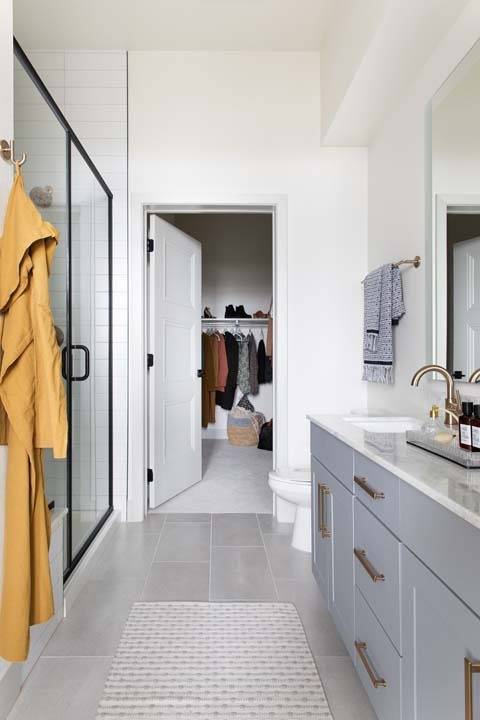 Spa-inspired bathrooms boast quartz countertops, glass showers with floor-to-ceiling tile, and spacious closets in select homes.*