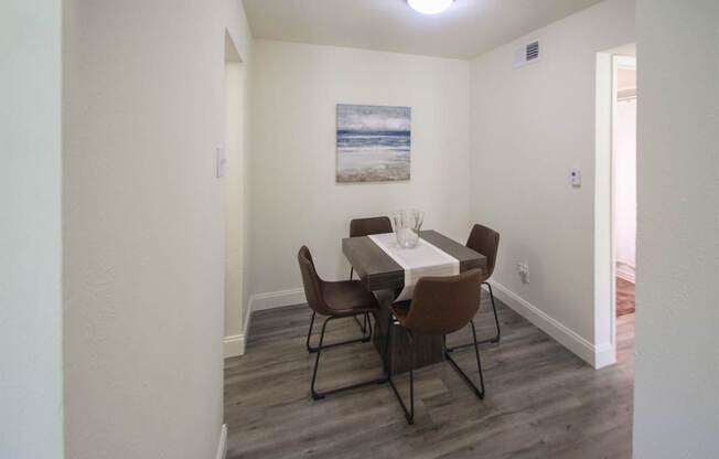 This is a photo of the dining room in the 558 square foot 1 bedroom, 1 bath model apartment at The Summit at Midtown Apartments in Dallas, TX.