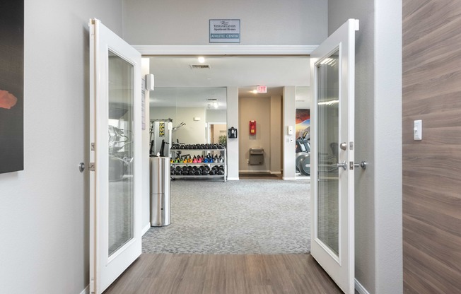 a view of a lobby with open doors and a wall with a bike rack