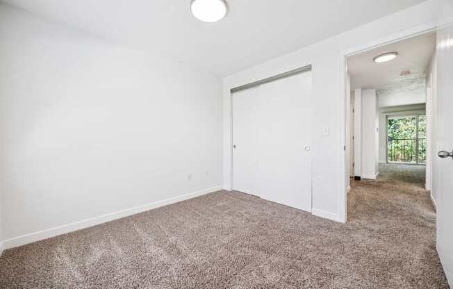 A room with a carpeted floor and a white door.