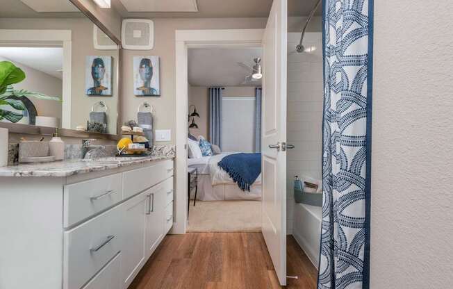 A bathroom with a white shower curtain.