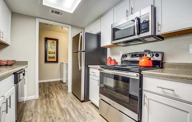 Kitchen with appliances and view to hall