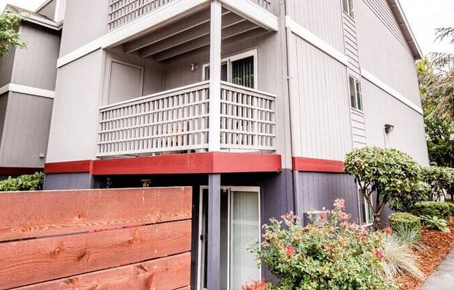 A grey building with a red fence in front. at Notch 8, Tacoma