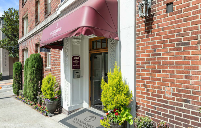 Property Entrance of brick building with a red awning at Stockbridge Apartment Homes, Washington