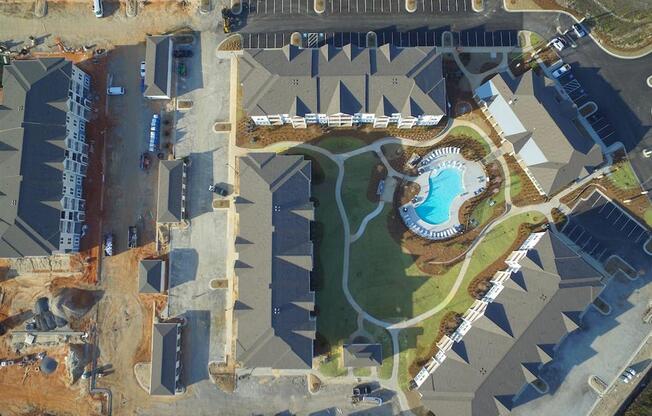 an aerial view of a swimming pool in the middle of a city