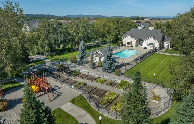 an aerial view of a backyard with a pool and a house