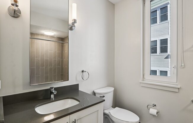 Bathroom with a sink and mirror at Park77 Apartments, Cambridge