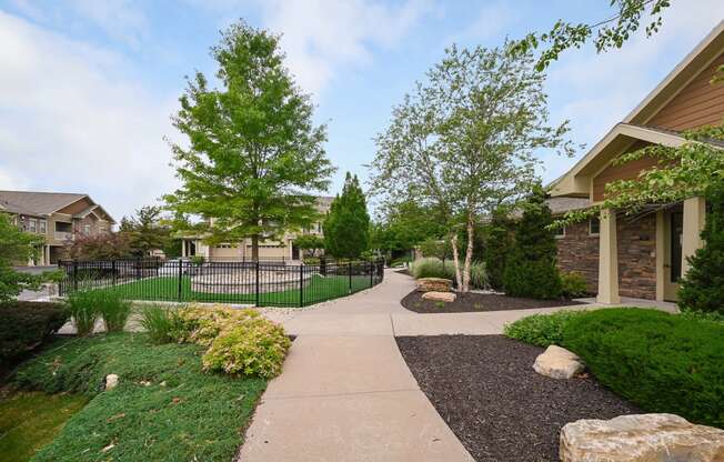 the walkway through the neighborhood is lined with trees and bushes at Sovereign at Overland Park, Overland Park, 66213  